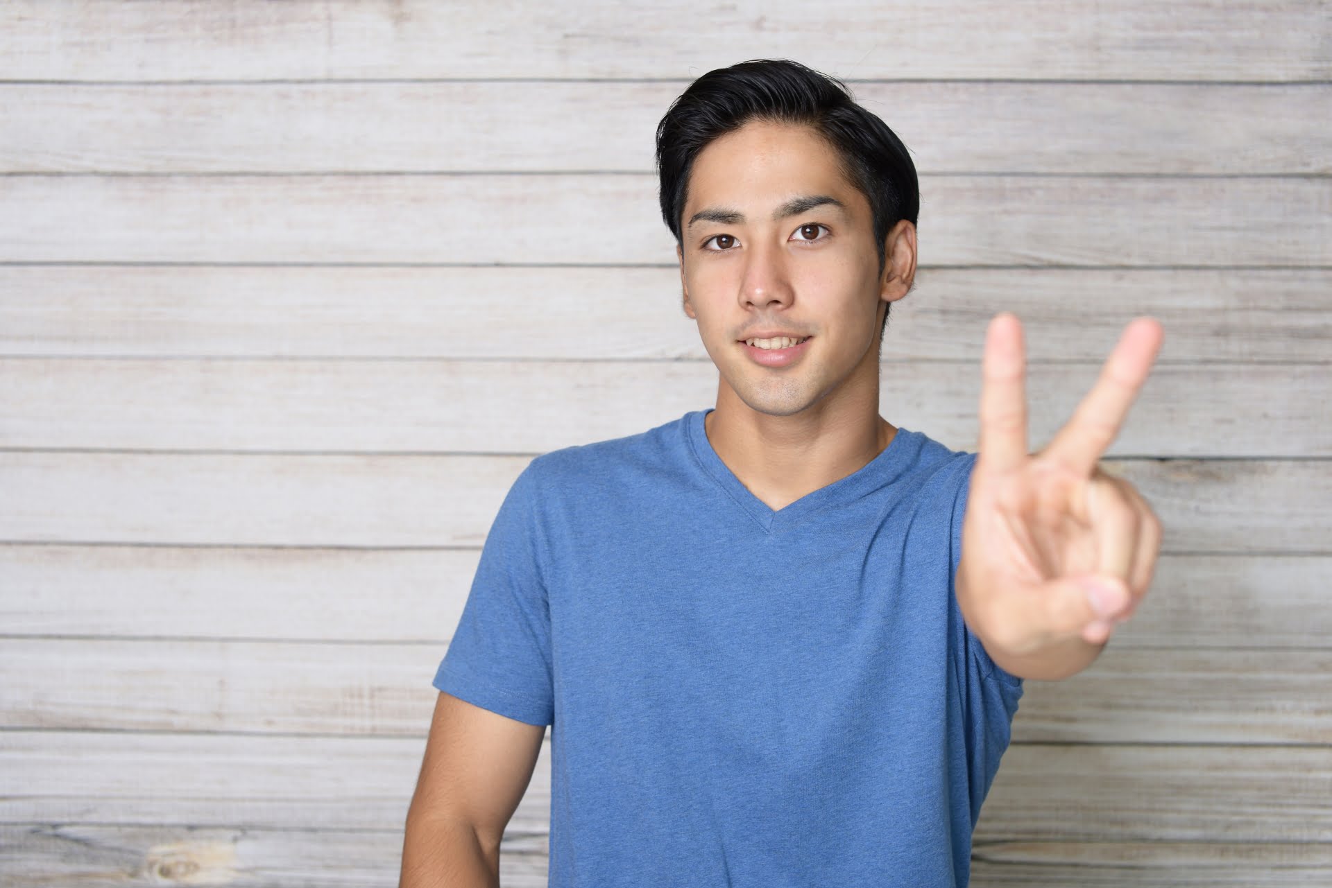 Vサインをする男性